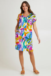 Model Madeline wearing size 10 of the Melinda White Shift Short Sleeve Dress in colour White (Blue), from the front, showing the whole outfit