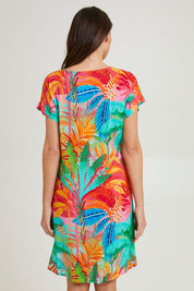 Model Madeline wearing size 10 of the Alisa Shift Short Sleeve Dress in colour Print (Green), from the back