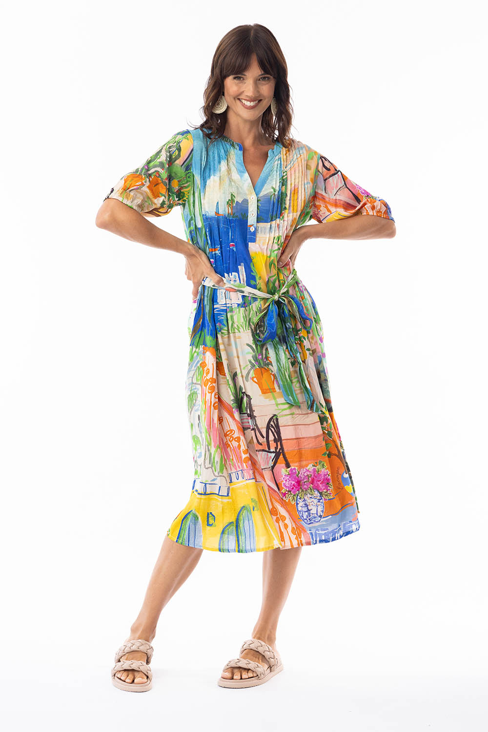 A model wearing the Sardinia Tie Waist Dress in colour Print, from the front, showing the whole outfit
