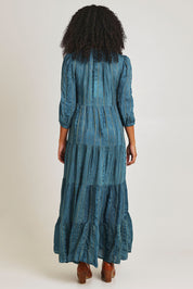 Model Ziara wearing size 10 of the Solid Dobby Maxi Layers Dress in colour Teal (Blue), from the back