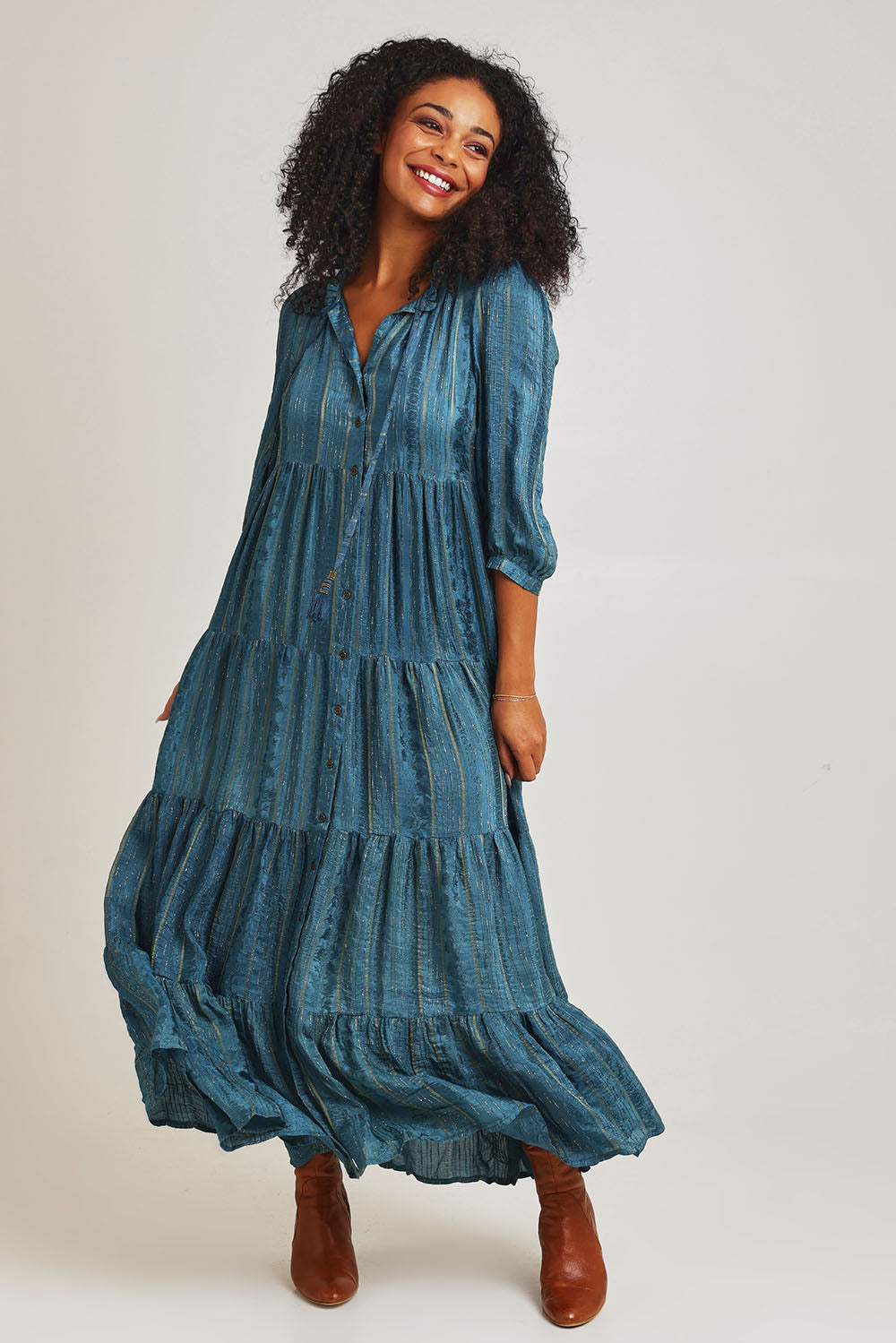 Model Ziara wearing size 10 of the Solid Dobby Maxi Layers Dress in colour Teal (Blue), from the front, showing the whole outfit