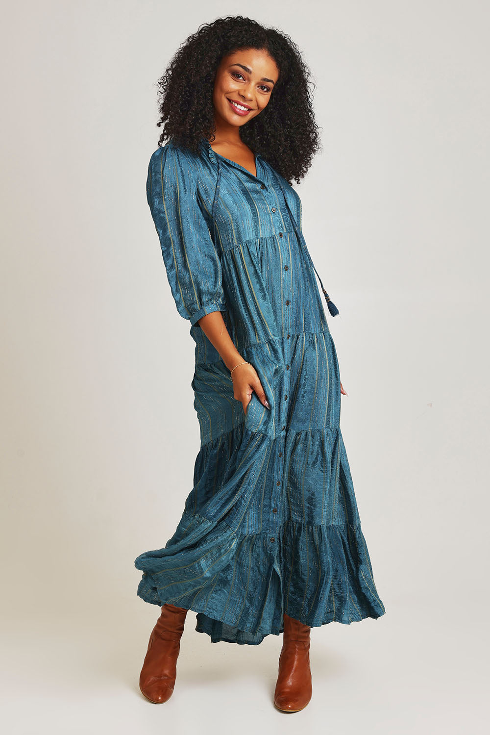 Model Ziara wearing size 10 of the Solid Dobby Maxi Layers Dress in colour Teal (Blue), from the front, showing the whole outfit