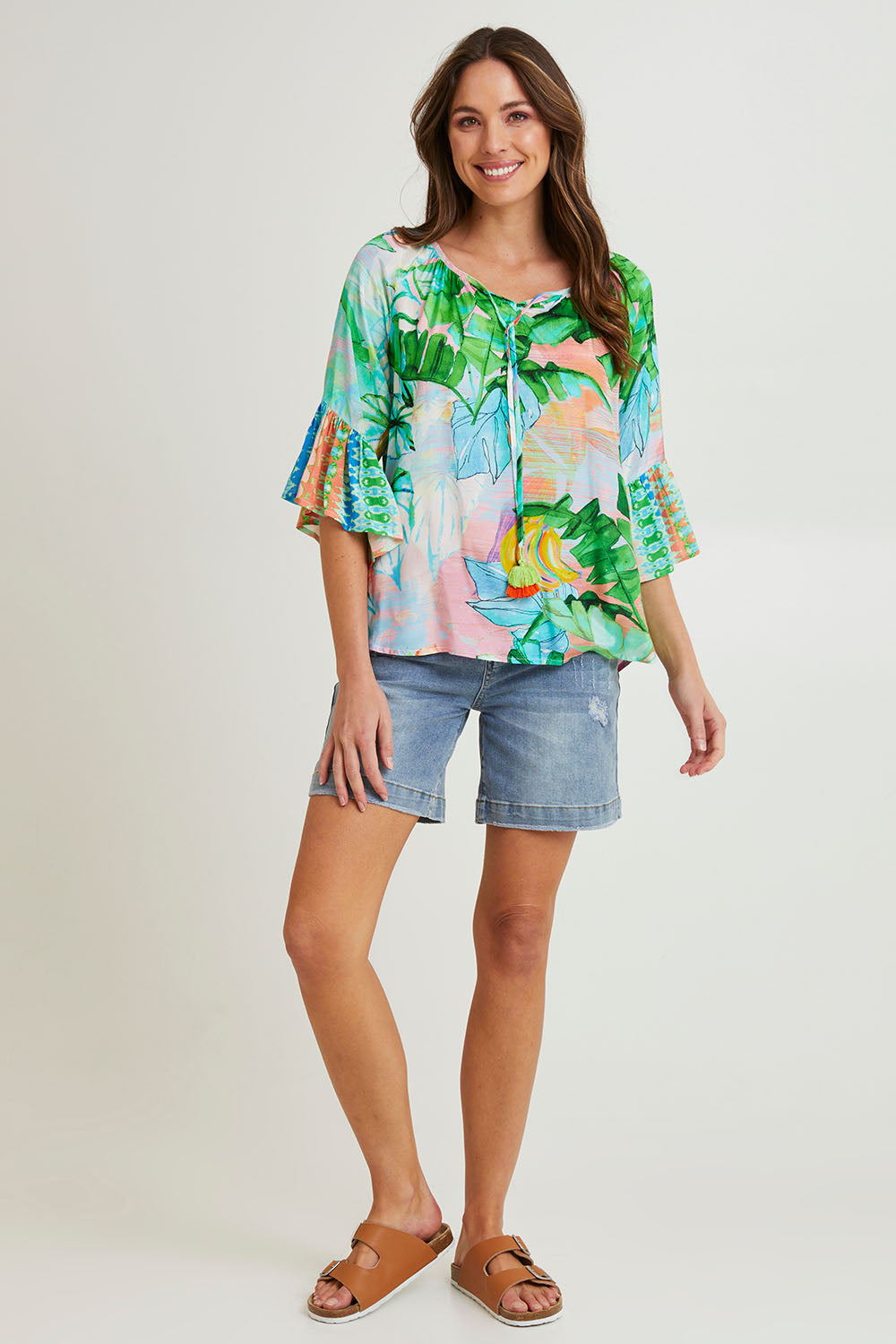 Model Madeline wearing size 10 of the Talia Boho Top in colour Print (Green), from the front, showing the whole outfit