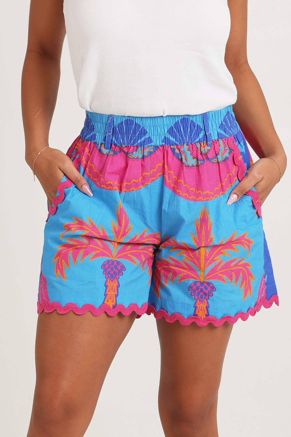 Model Ziara wearing size 10 of the Celestial Blue Cotton Shorts in colour Blue, from the front, cropped image