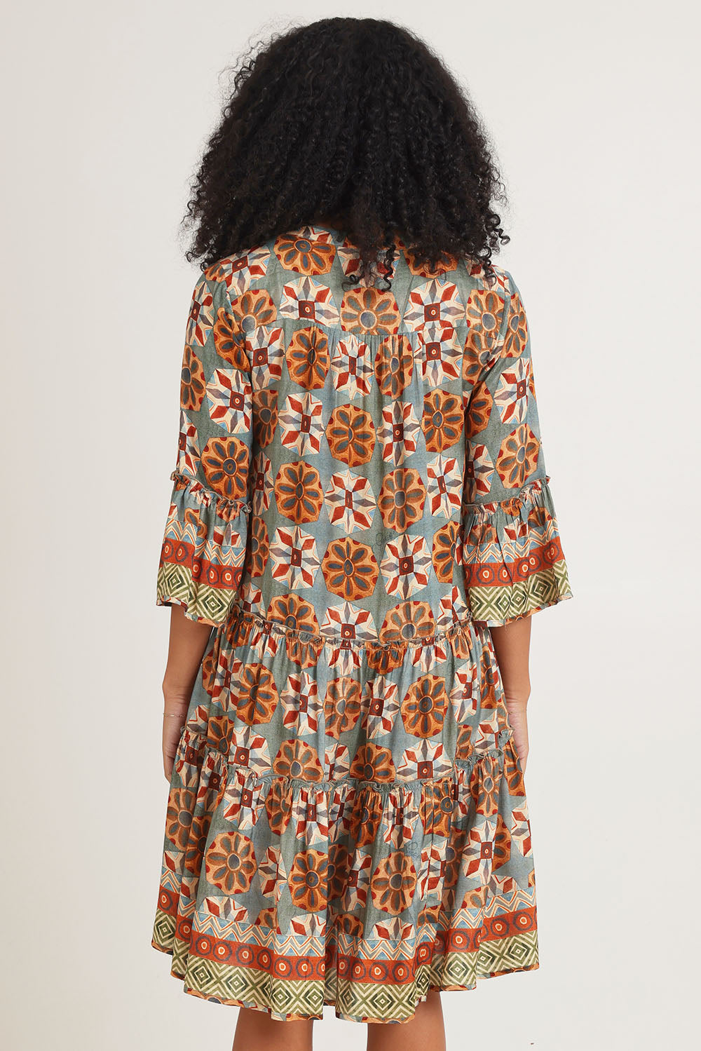 Model Ziara wearing size 10 of the Vera Frill Sleeve Layers Dress in colour Print, from the back
