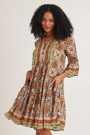Model Ziara wearing size 10 of the Vera Frill Sleeve Layers Dress in colour Print, from the front, cropped image