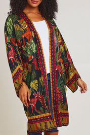 Model Ziara wearing size 10 of the Amazonia Kimono in colour Amazonia, from the front, cropped image