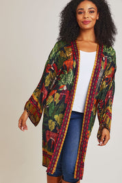 Model Ziara wearing size 10 of the Amazonia Kimono in colour Amazonia, from the front, cropped image