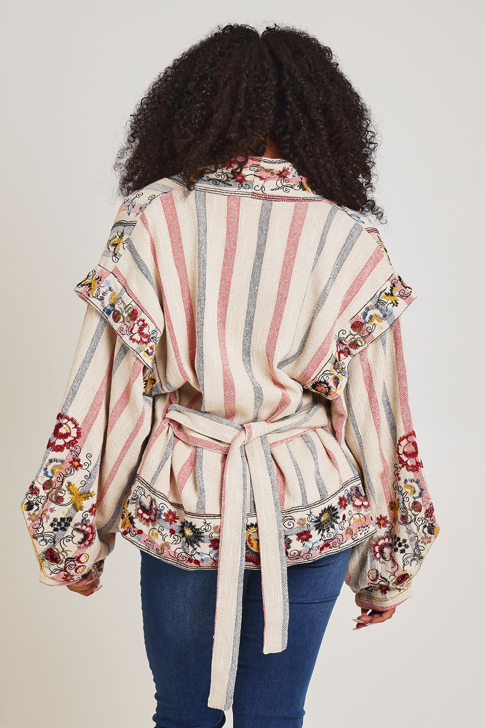 Model Ziara wearing size 10 of the Embroidered Cotton Jacket in colour Print, from the back