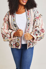 Model Ziara wearing size 10 of the Embroidered Cotton Jacket in colour Print, from the front, cropped image