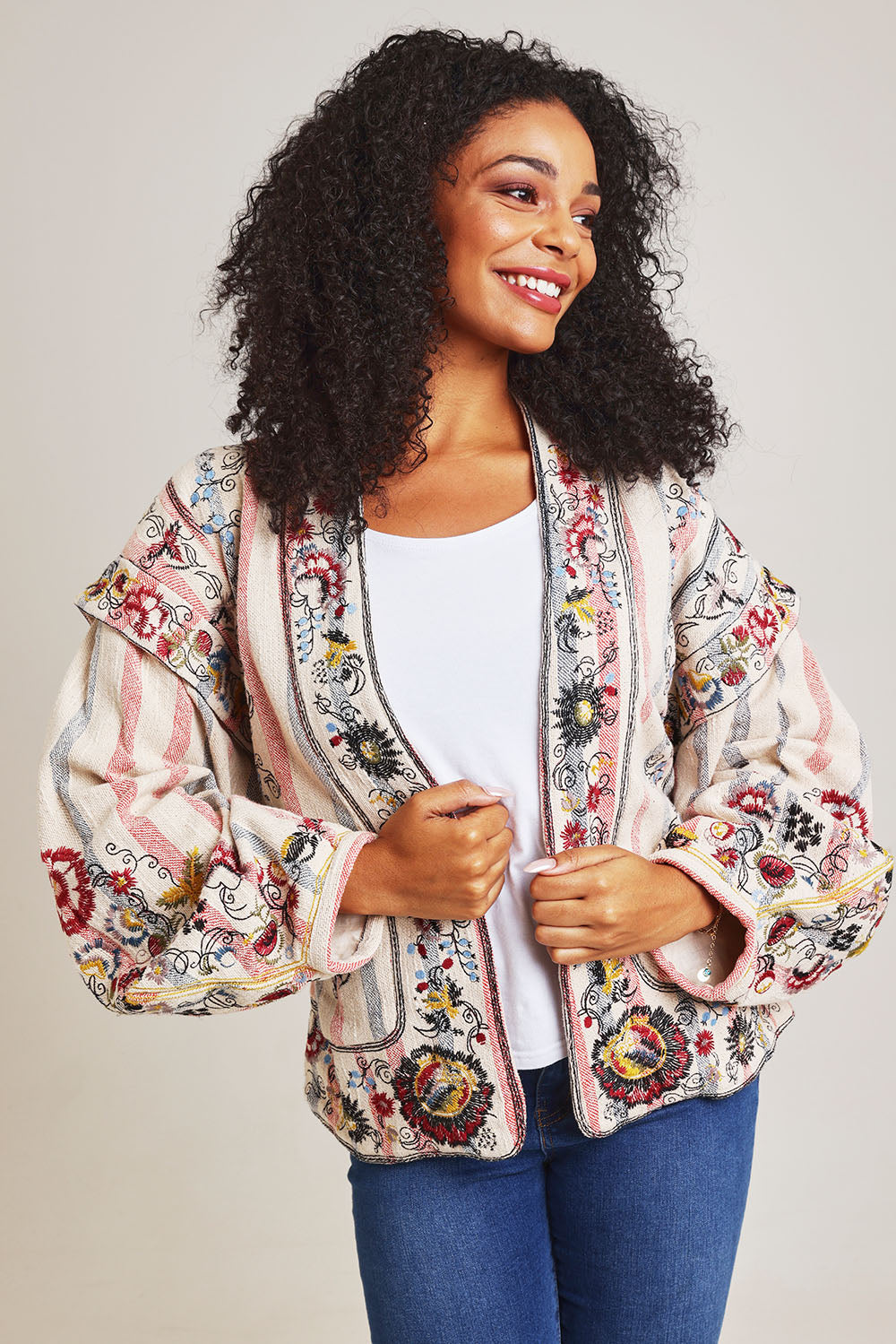 Model Ziara wearing size 10 of the Embroidered Cotton Jacket in colour Print, from the front, cropped image