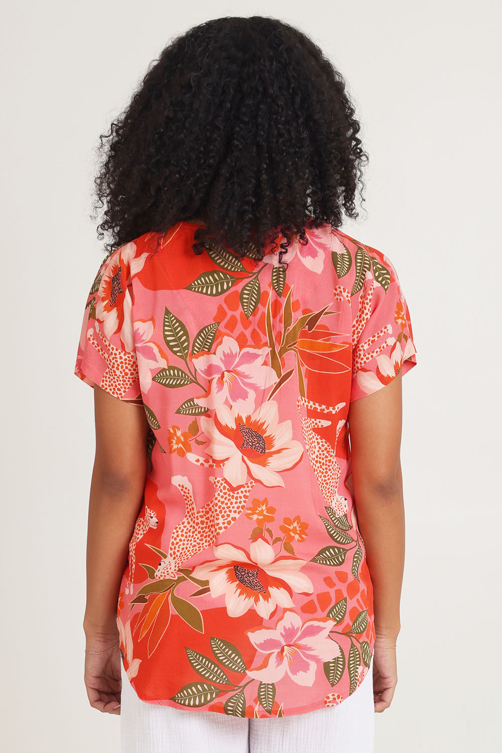 Model Ziara wearing size 10 of the Aria V Neck Top in colour Print (Pink), from the back