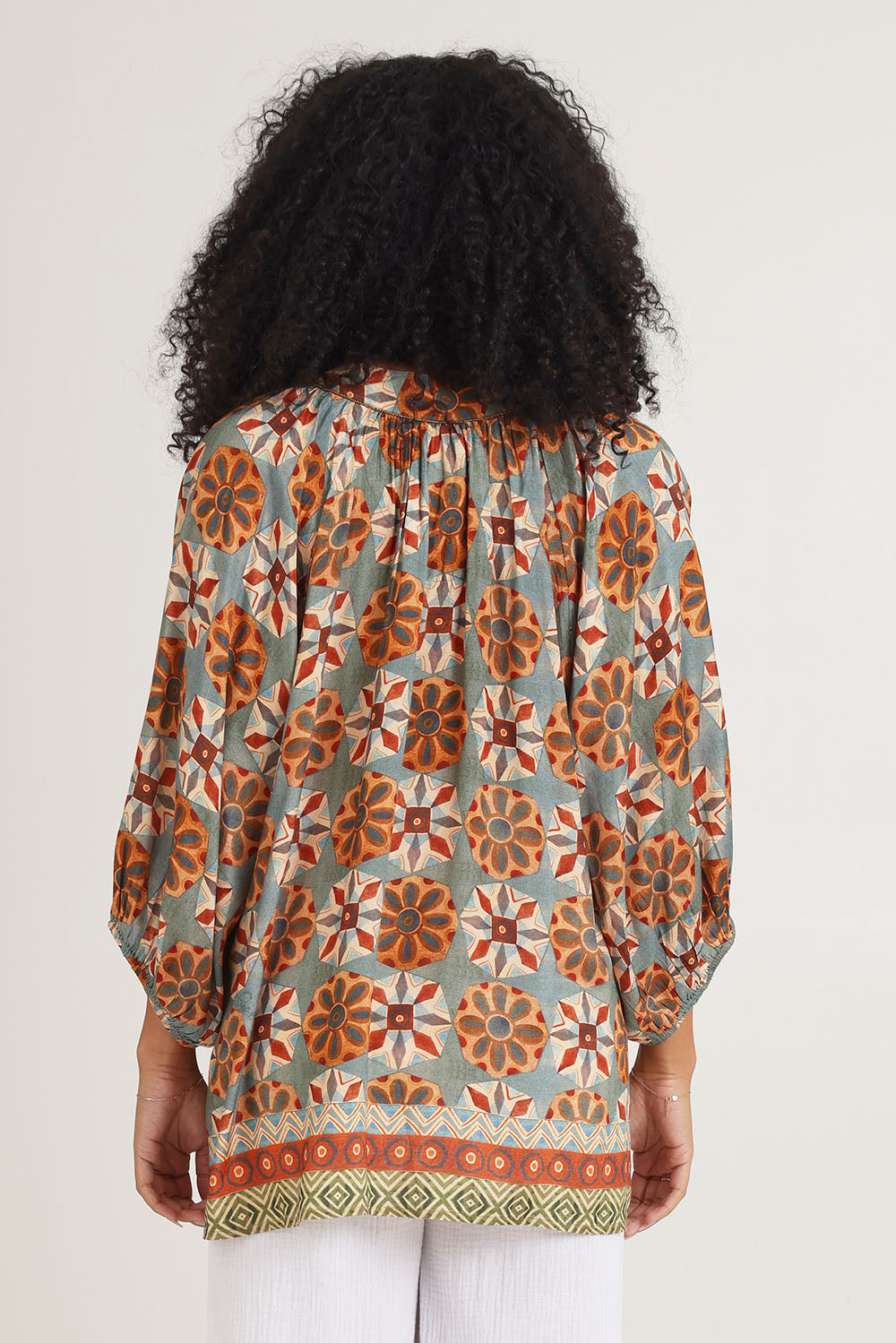 Model Ziara wearing size 10 of the Vera Top in colour Print, from the back