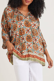 Model Ziara wearing size 10 of the Vera Top in colour Print, from the front, cropped image