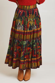 Model Ziara wearing size 10 of the Amazonia Skirt in colour Amazonia, from the front, cropped image
