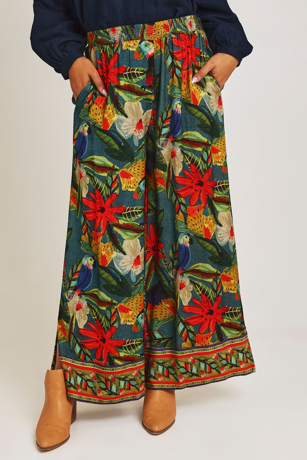 Model Ziara wearing size 10 of the Galapagos Pant in colour Galapagos, from the front, cropped image
