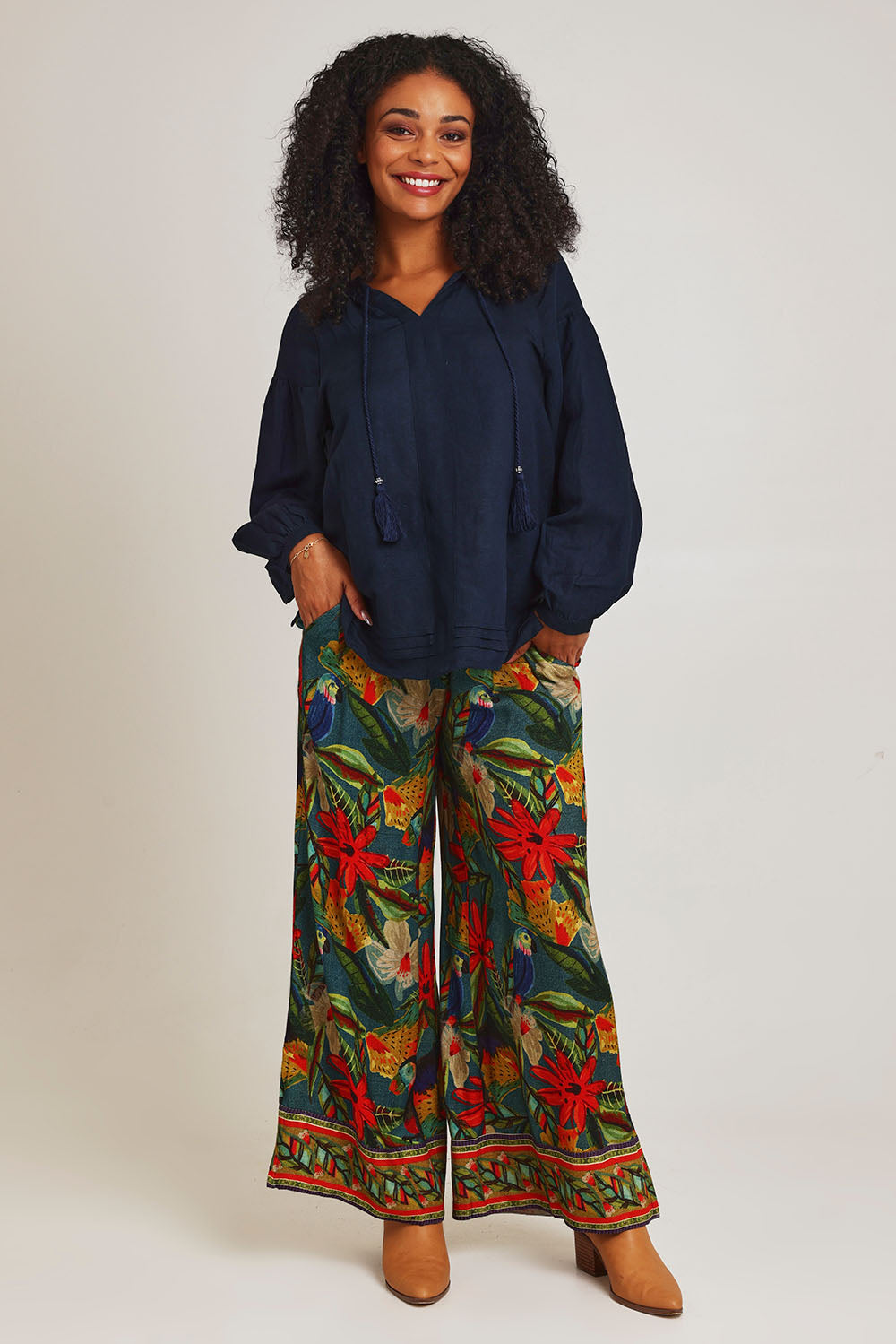 Model Ziara wearing size 10 of the Galapagos Pant in colour Galapagos, from the front, showing the whole outfit