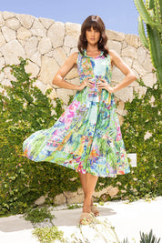A model wearing the Darcie Boho Sleeveless Dress in colour Print (Green), from the front, showing the whole outfit