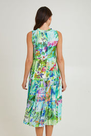 Model Madeline wearing size 10 of the Darcie Boho Sleeveless Dress in colour Print (Green), from the back