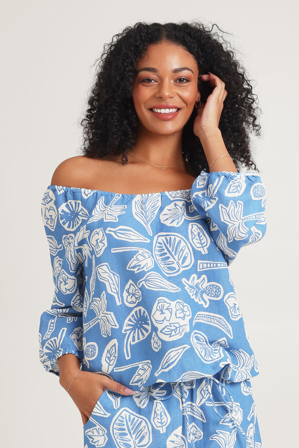 Model Ziara wearing size 10 of the Linen Gather Neck 3/4 Sleeve Top in colour Blue (Blue), from the front, cropped image