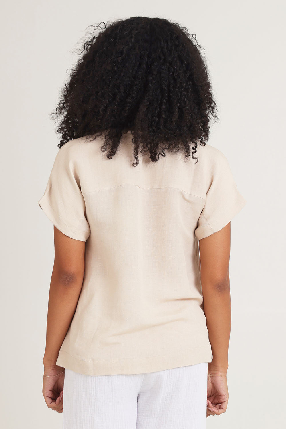 Model Ziara wearing size 10 of the Linen Boxy Top in colour Sand, from the back