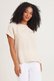 Model Ziara wearing size 10 of the Linen Boxy Top in colour Sand, from the front, cropped image