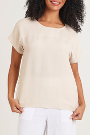 Model Ziara wearing size 10 of the Linen Boxy Top in colour Sand, from the front, cropped image