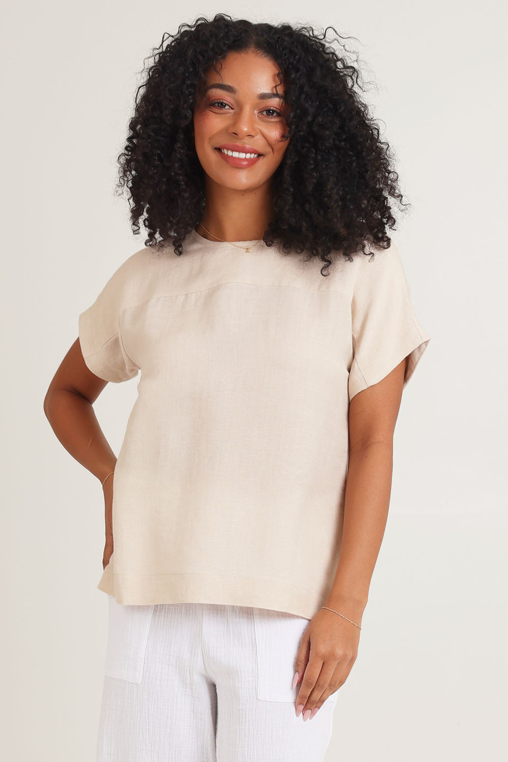 Model Ziara wearing size 10 of the Linen Boxy Top in colour Sand, from the front, cropped image