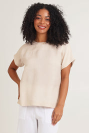 Model Ziara wearing size 10 of the Linen Boxy Top in colour Sand, from the front, cropped image