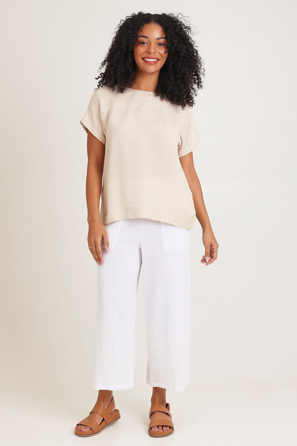 Model Ziara wearing size 10 of the Linen Boxy Top in colour Sand, from the front, showing the whole outfit