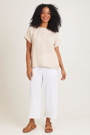 Model Ziara wearing size 10 of the Linen Boxy Top in colour Sand, from the front, showing the whole outfit