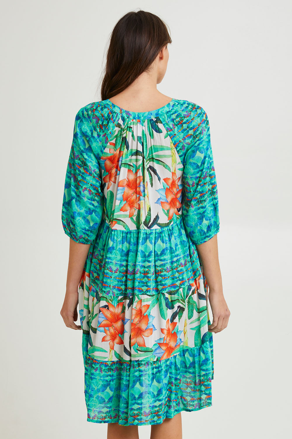 Model Madeline wearing size 10 of the Olivia Layers 3/4 Sleeve Dress in colour Print (Blue), from the back