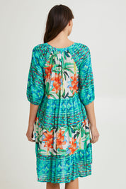 Model Madeline wearing size 10 of the Olivia Layers 3/4 Sleeve Dress in colour Print (Blue), from the back