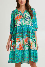 Model Madeline wearing size 10 of the Olivia Layers 3/4 Sleeve Dress in colour Print (Blue), from the front, cropped image