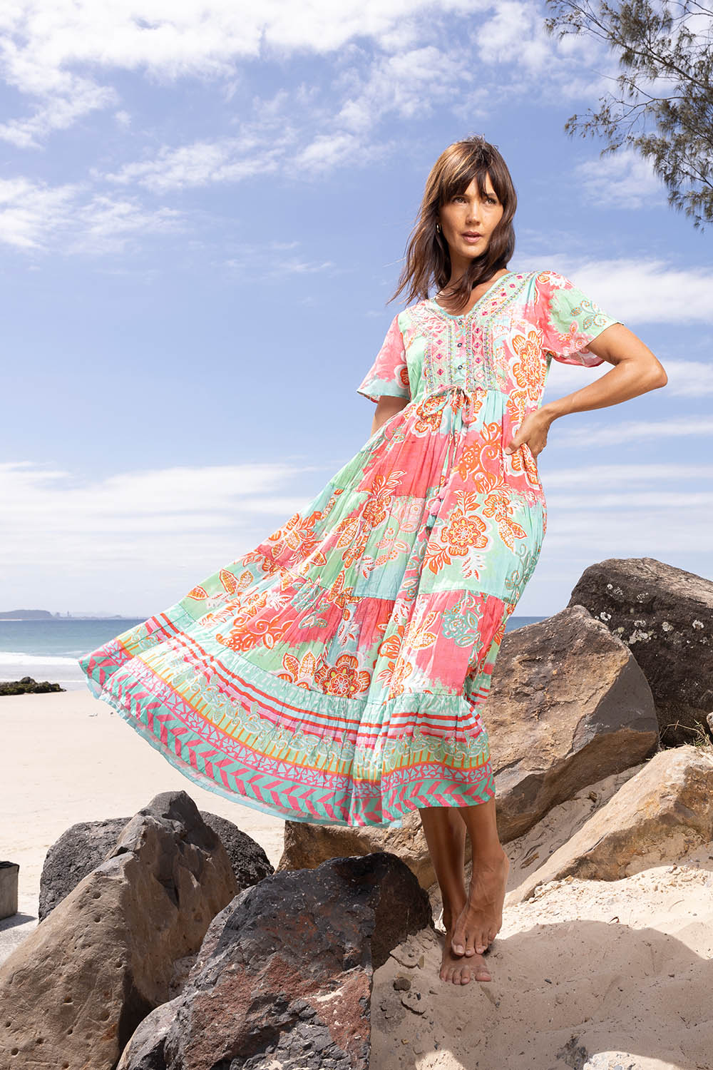 A model wearing the Sarah Midi Dress in colour Print (Green), from the front, showing the whole outfit
