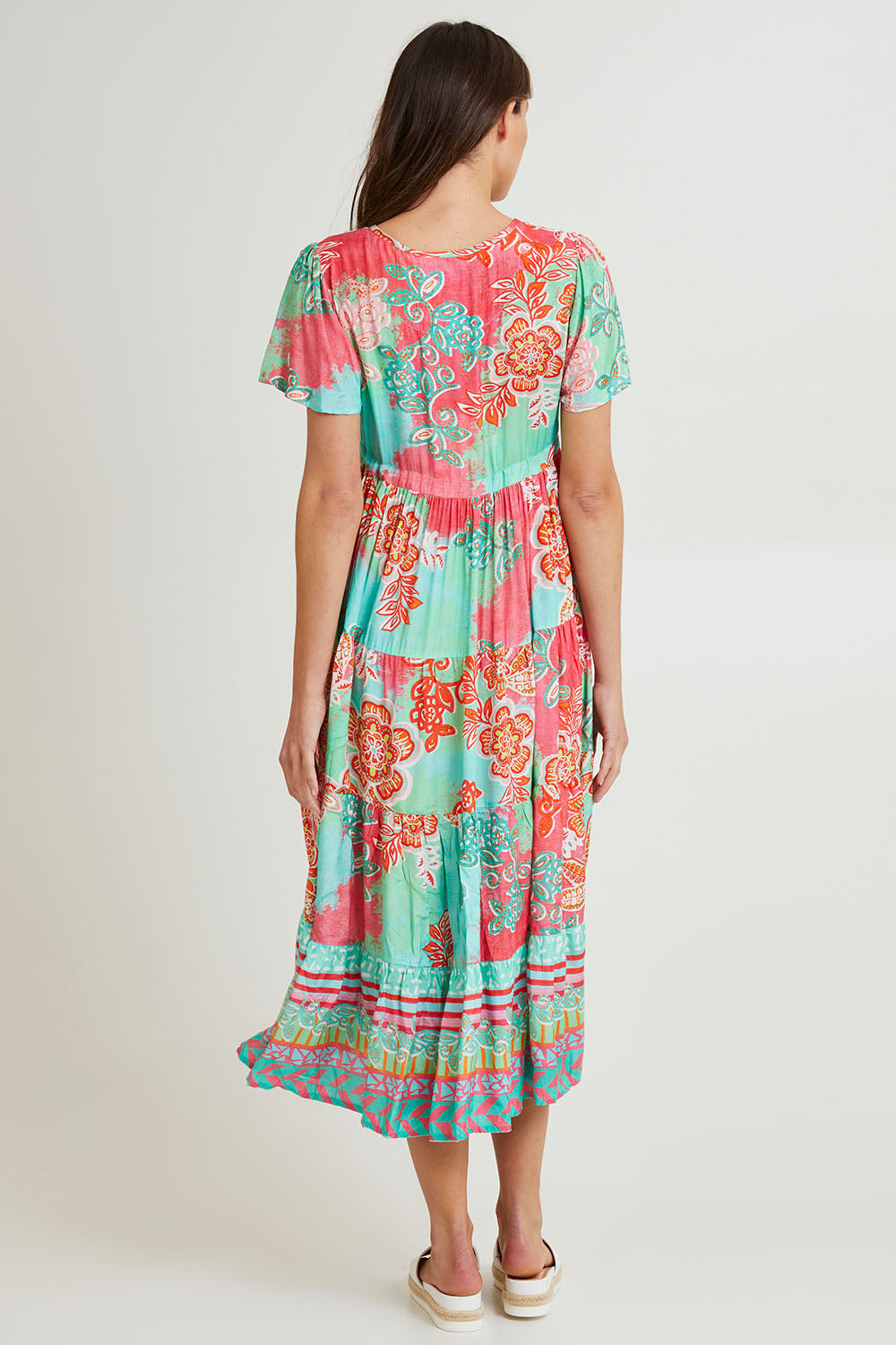 Model Madeline wearing size 10 of the Sarah Midi Dress in colour Print (Green), from the back