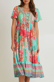 Model Madeline wearing size 10 of the Sarah Midi Dress in colour Print (Green), from the front, cropped image
