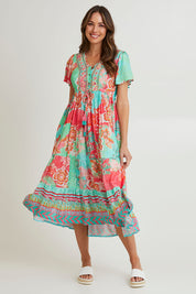 Model Madeline wearing size 10 of the Sarah Midi Dress in colour Print (Green), from the front, showing the whole outfit