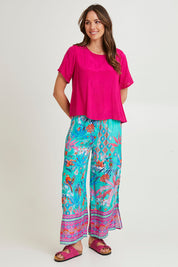 Model Madeline wearing size 10 of the Marina Pant in colour Print (Blue), from the front, showing the whole outfit
