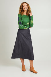 Model Emma wearing size S of the Amy Skirt in colour Denimindig (Blue), from the front, showing the whole outfit