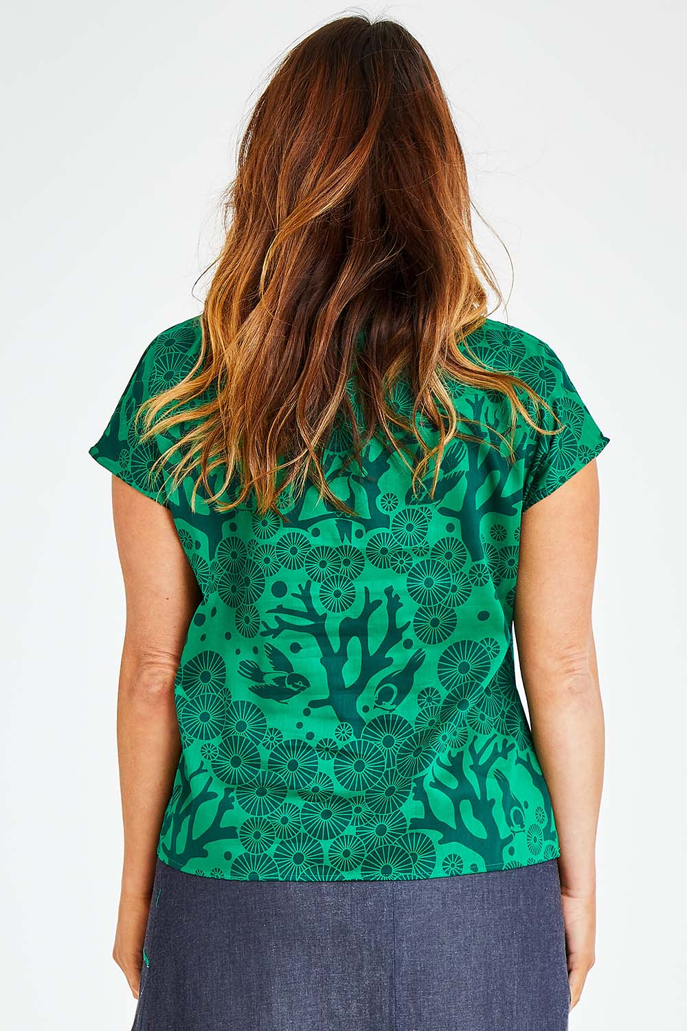 Model Laura wearing size L of the Mikko Tilly Top in colour Emerald (Green), from the back
