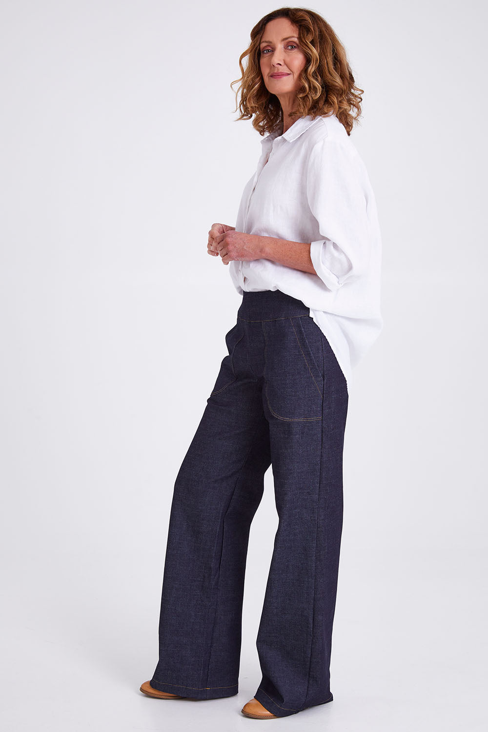 Model Emma wearing size S of the Gabby Denim Pants in colour Indigo (Blue), from the front, showing the whole outfit