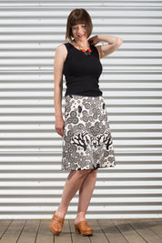 A model wearing the Mikko Aline Skirt in colour InkNatural, from the front, showing the whole outfit