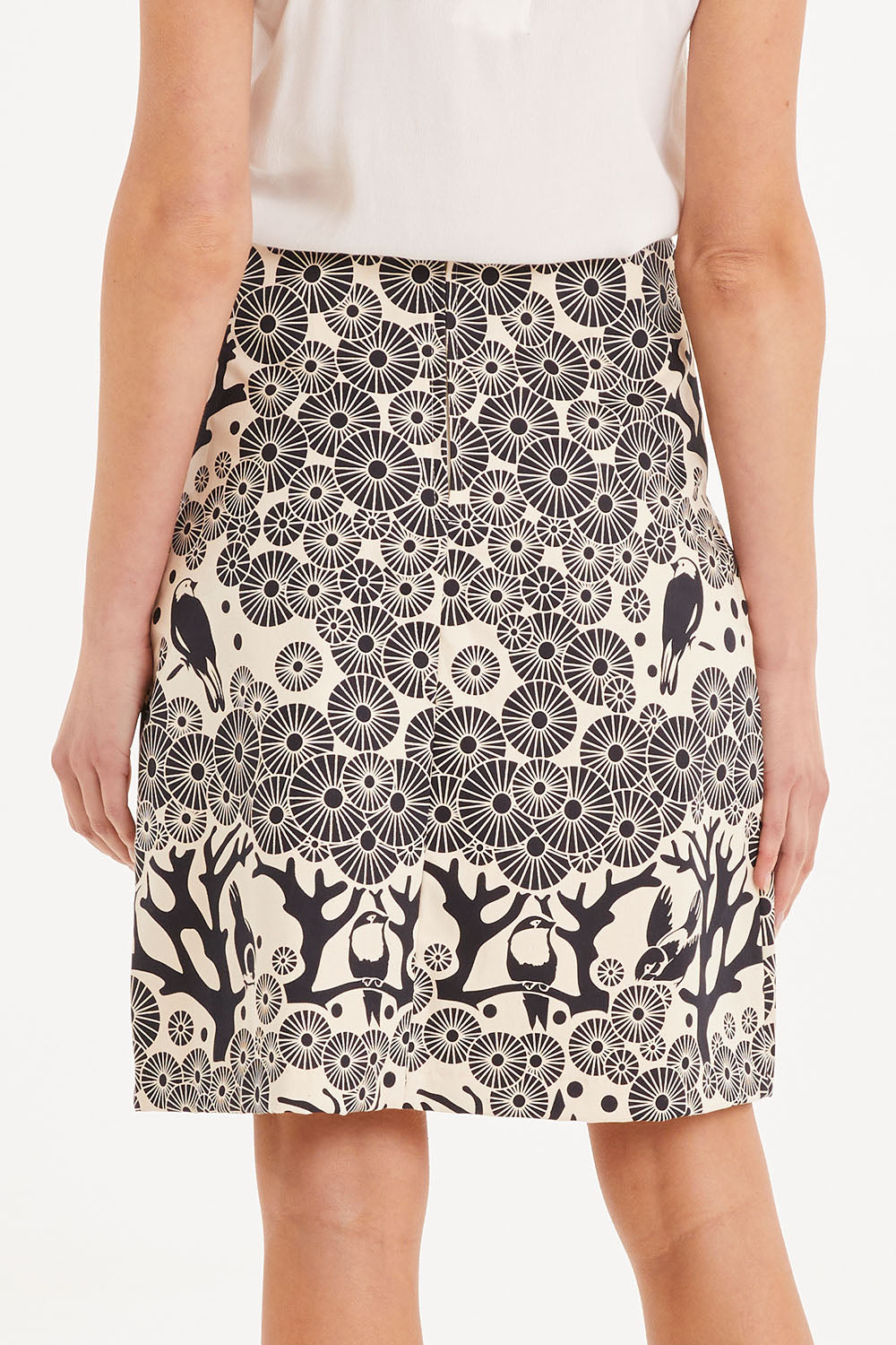Model Madeline wearing size S of the Mikko Aline Skirt in colour InkNatural, from the back