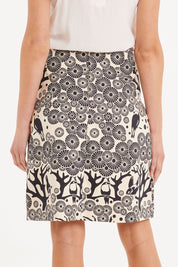 Model Madeline wearing size S of the Mikko Aline Skirt in colour InkNatural, from the back