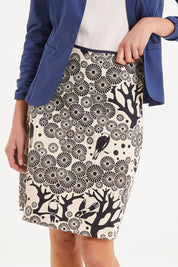 Model Madeline wearing size S of the Mikko Aline Skirt in colour InkNatural, from the front, cropped image