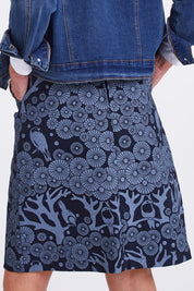 Model Emma wearing size S of the Mikko Zoe Skirt in colour Navy (Blue), from the back