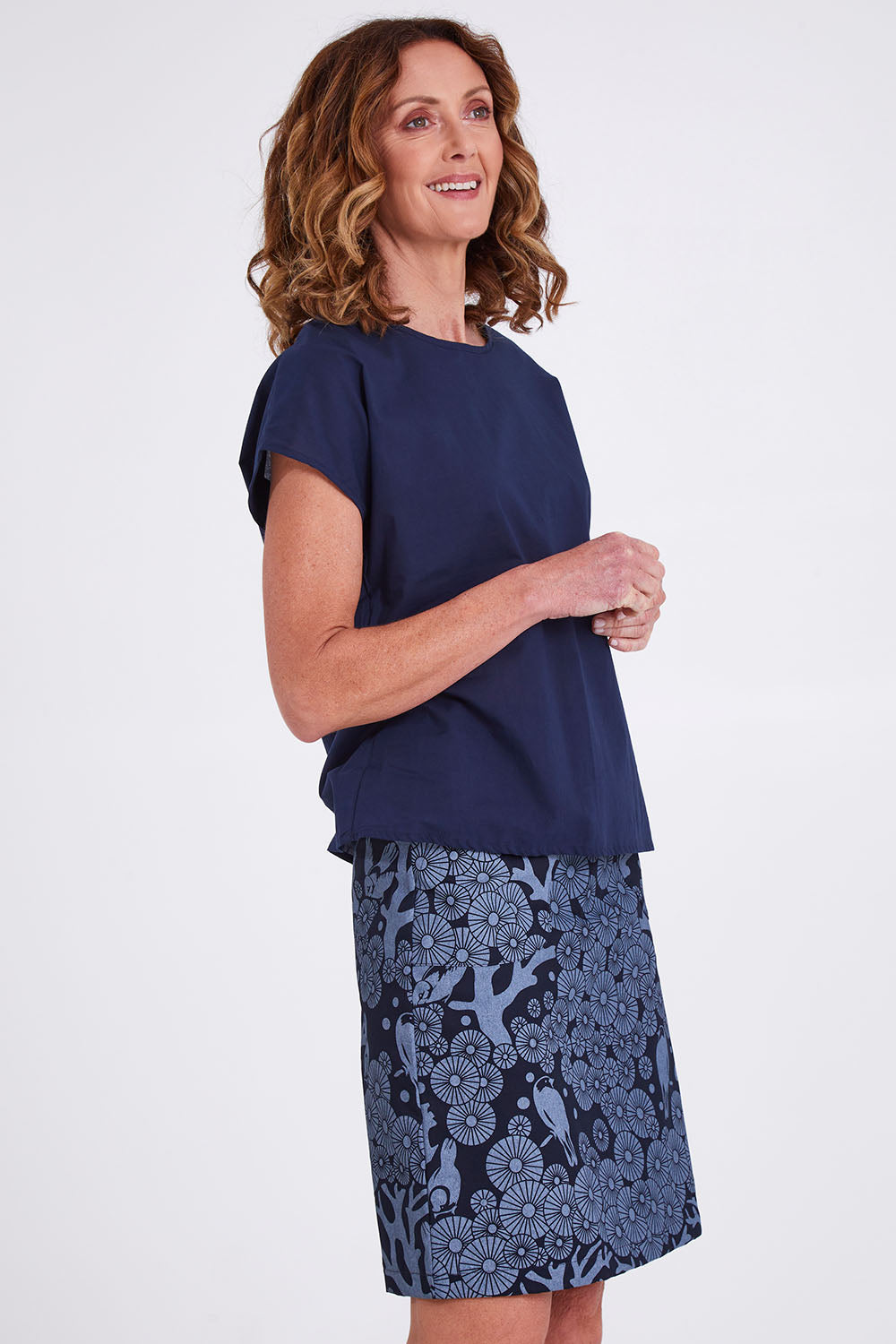 Model Emma wearing size S of the Mikko Zoe Skirt in colour Navy (Blue), from the front, cropped image