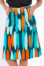 Model Schanez wearing size S of the Avril Skirt Long in colour Orange (Blue), from the front, cropped image