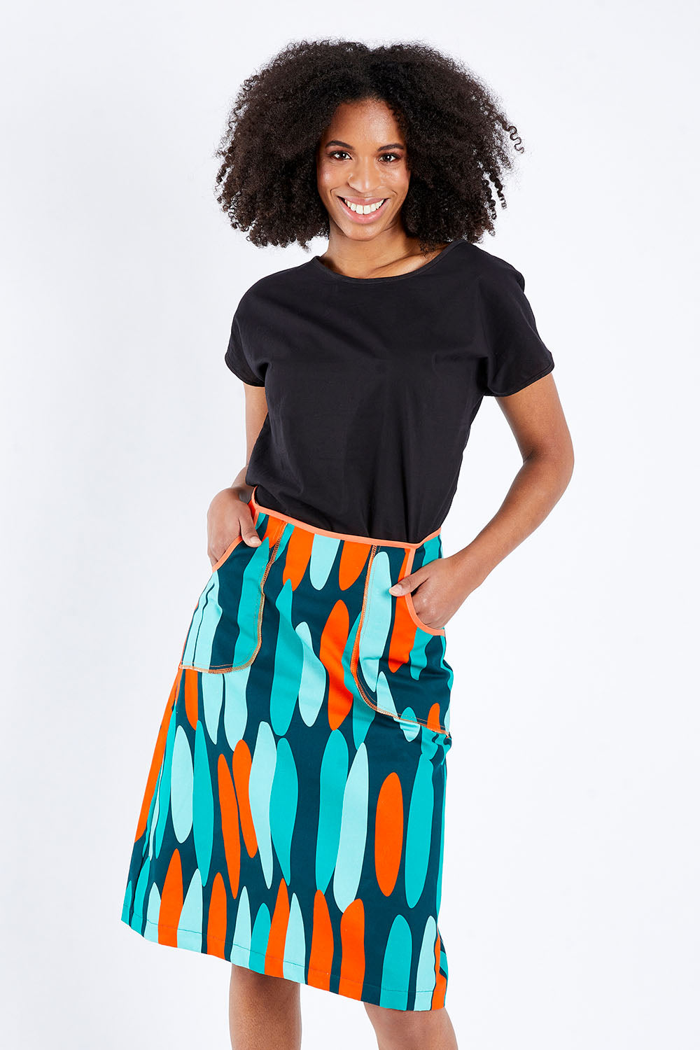 Model Schanez wearing size S of the Avril Skirt Long in colour Orange (Blue), from the front, cropped image